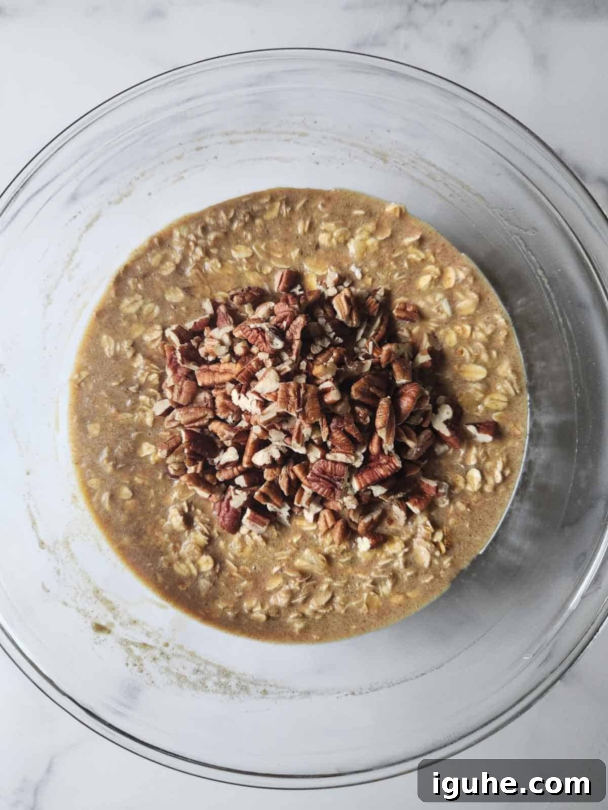 Decadent Pecan Pie Baked Oatmeal 6 Oatmeal batter with pecans folded in, ready for baking.