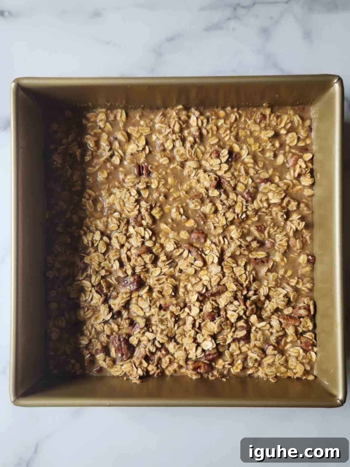 Decadent Pecan Pie Baked Oatmeal 7 Prepared batter for pecan pie oatmeal in a square pan, ready to bake.
