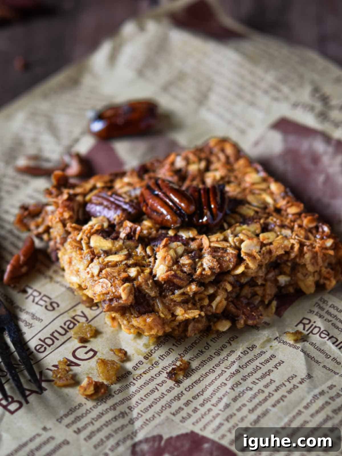 Decadent Pecan Pie Baked Oatmeal 9 Baked oatmeal with pecans on brown parchment paper, ready to be served or stored.