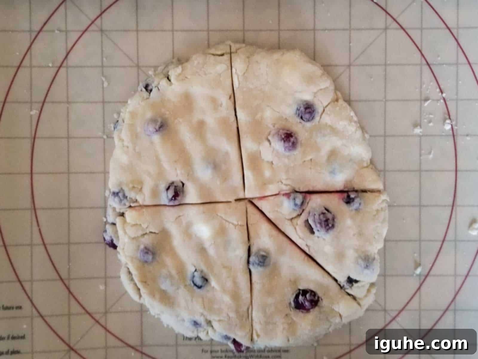 Blissful Cranberry Orange Cream Scones 6 Cutting scone dough into triangles.