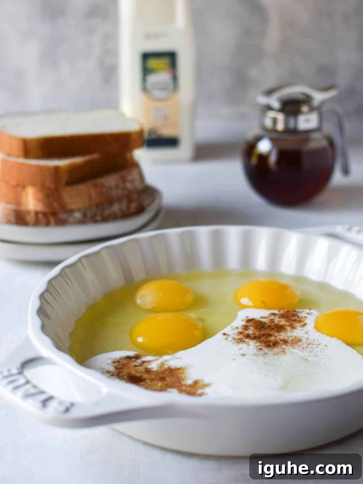 Repurposed Buttermilk French Toast 4 Eggs, buttermilk, and spices in a white shallow bowl, ready to be whisked for French toast custard.