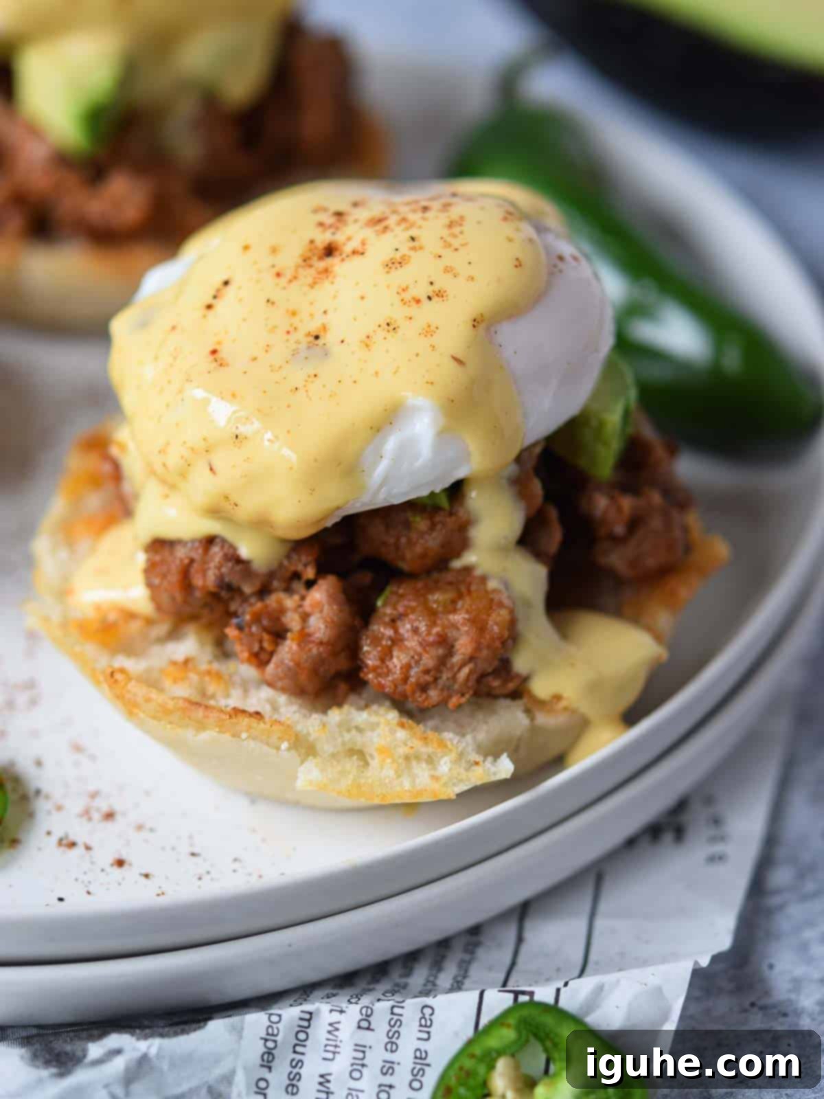 Fiesta Benedict with Chipotle Kick 12 A vibrant Mexican Eggs Benedict garnished with a fresh jalapeño slice, showcasing its inviting flavors.