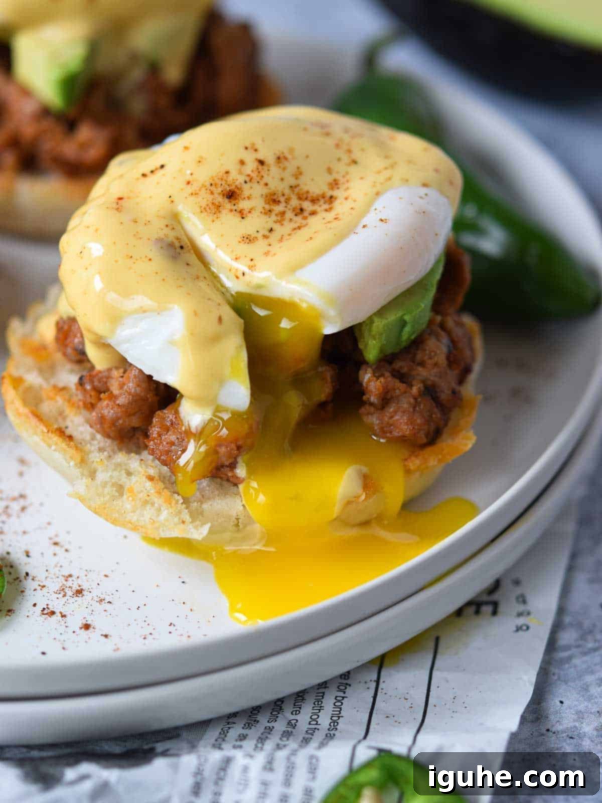 Fiesta Benedict with Chipotle Kick 13 Close-up of a Mexican Eggs Benedict, highlighting the perfectly runny yolk beneath the chipotle hollandaise.