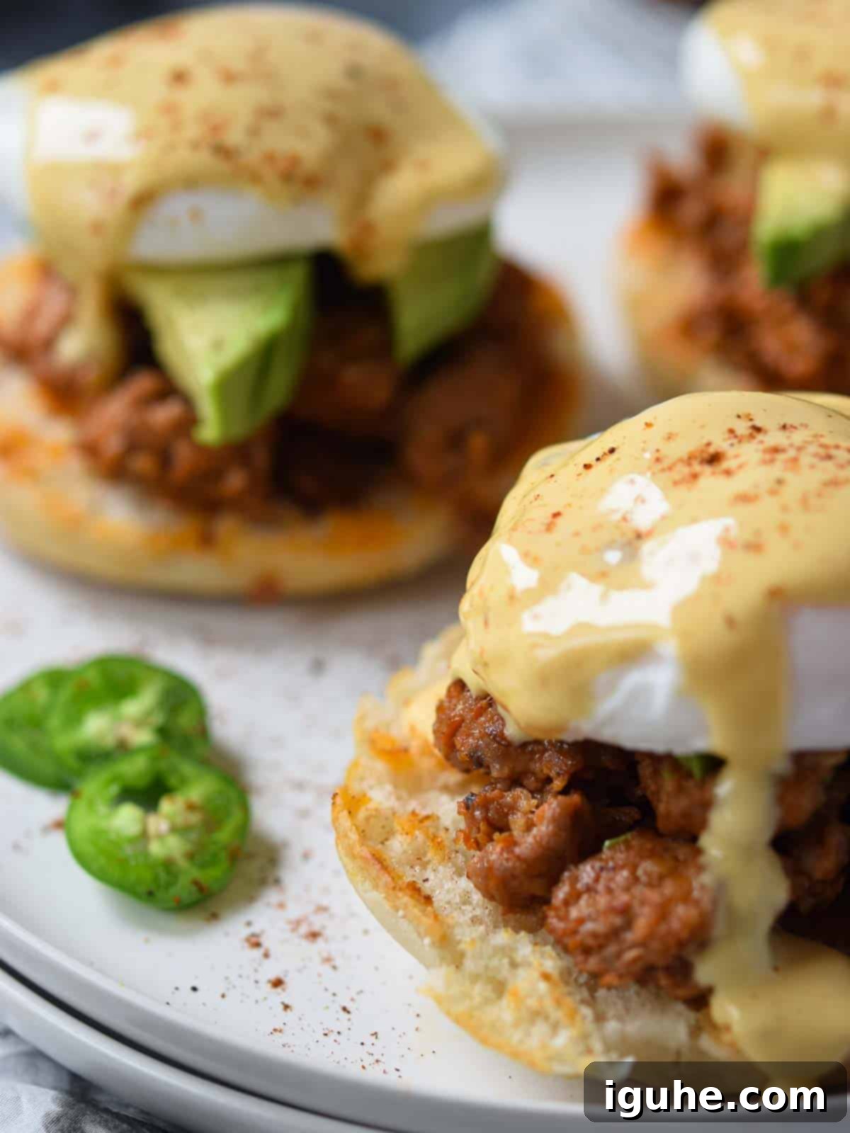 Fiesta Benedict with Chipotle Kick 3 Close-up of a single Mexican Eggs Benedict with a perfectly poached egg and glistening chipotle hollandaise sauce.