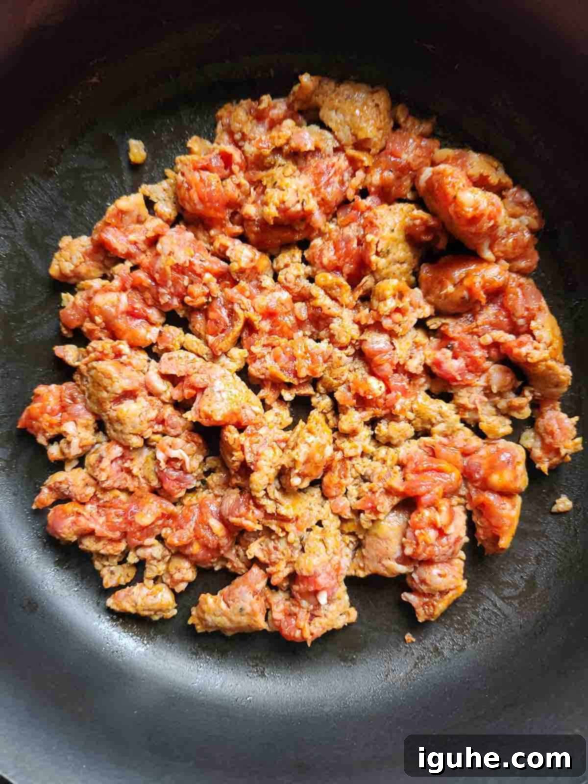 Fiesta Benedict with Chipotle Kick 4 Crumbled Mexican chorizo cooking in a non-stick skillet until browned.