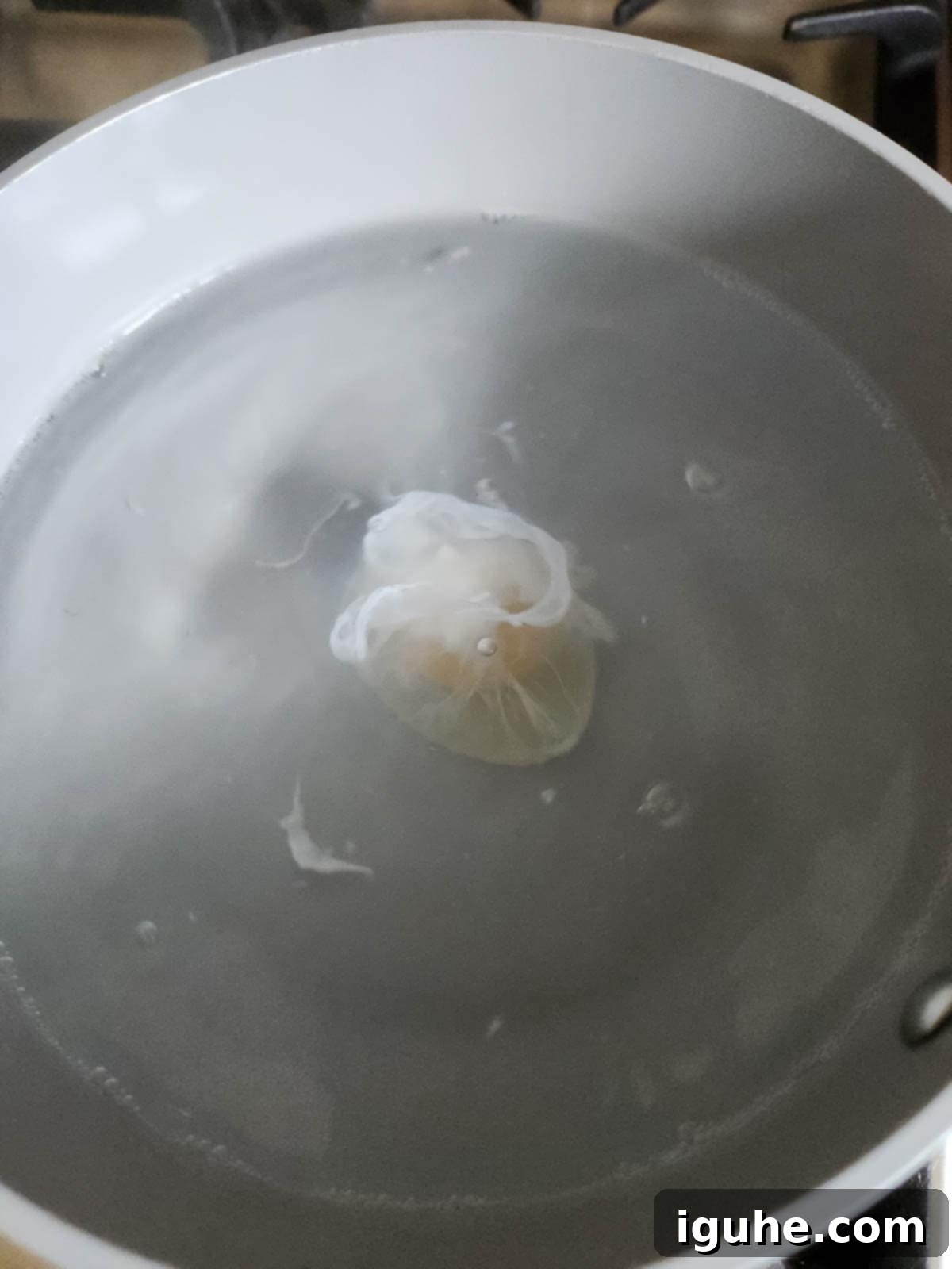 Fiesta Benedict with Chipotle Kick 8 A perfectly poached egg gently cooking in a pot of water.