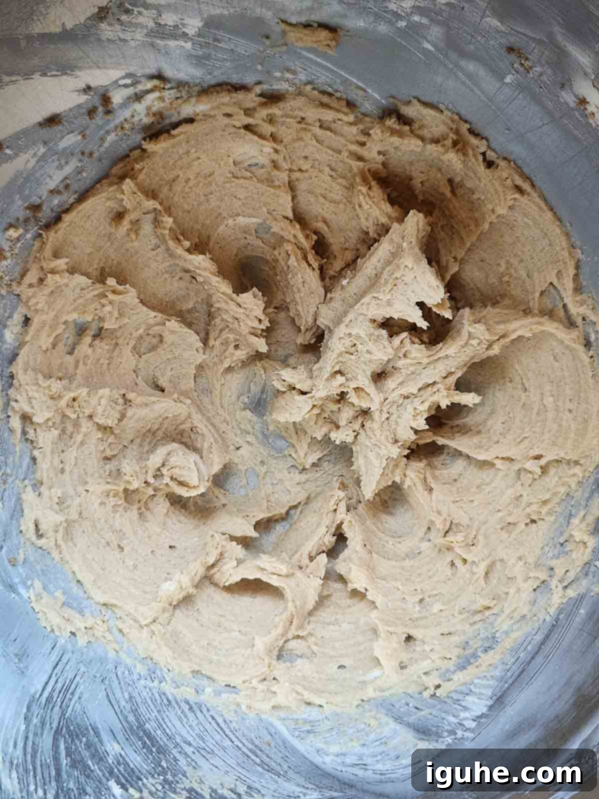 Gingerbread Cranberry Loaf 5 Creamed butter and brown sugar batter for gingerbread loaf in a metal bowl, showing a light and fluffy texture.