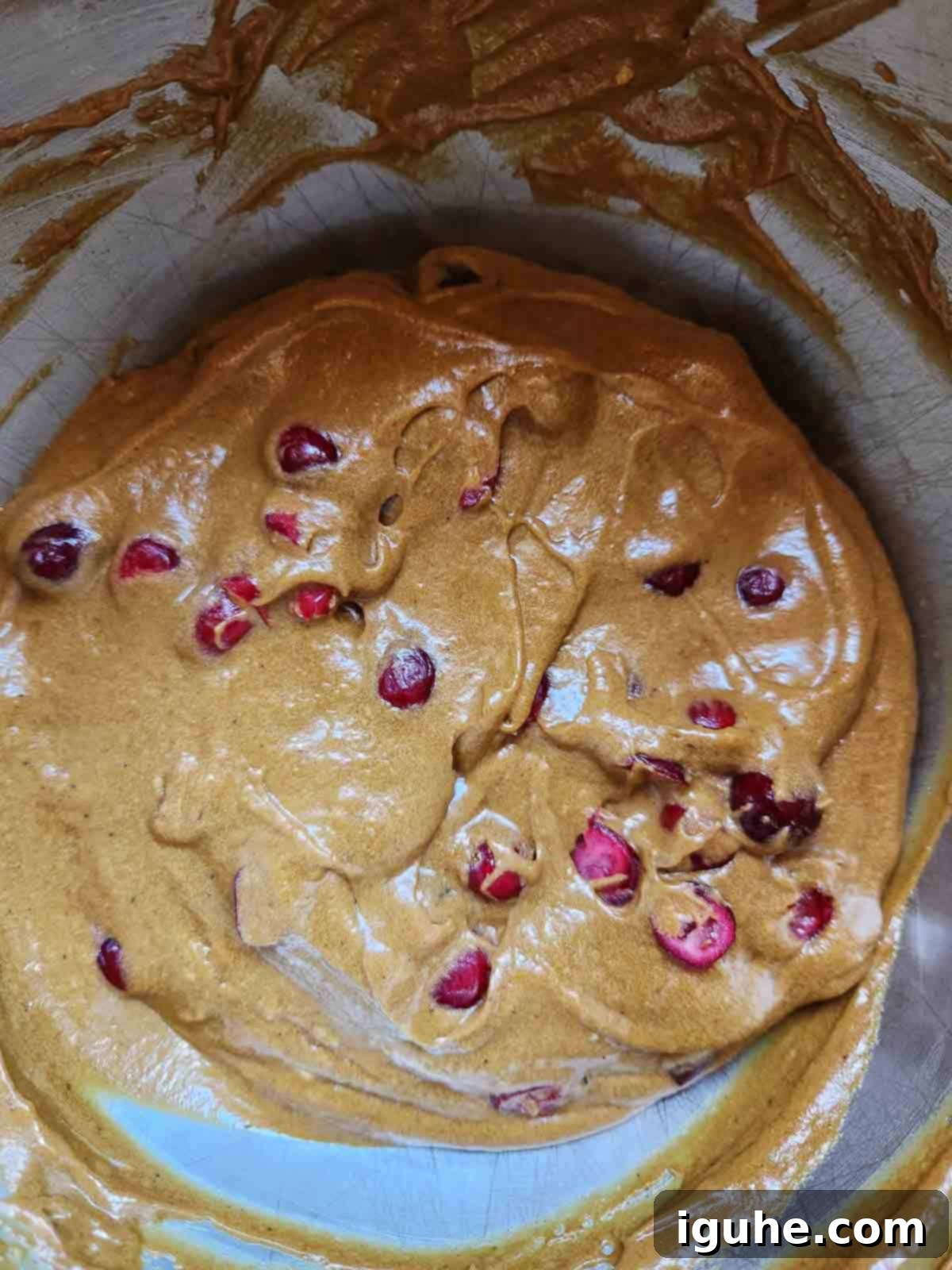 Gingerbread Cranberry Loaf 8 Final batter for cranberry loaf in a metal bowl, showing evenly distributed cranberries throughout the mixture.