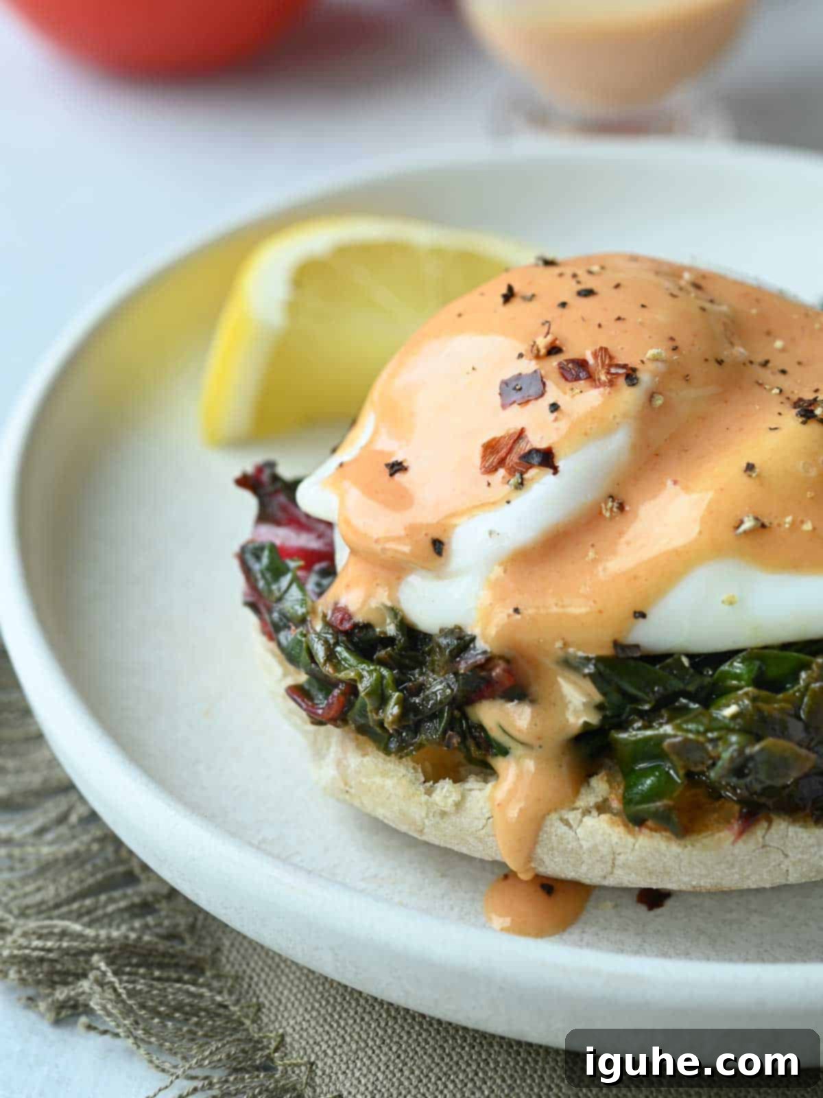 Swiss Chard Eggs Florentine with Zesty Tomato Hollandaise 10 Close-up of Eggs Florentine with luscious tomato hollandaise covering a poached egg and Swiss chard.