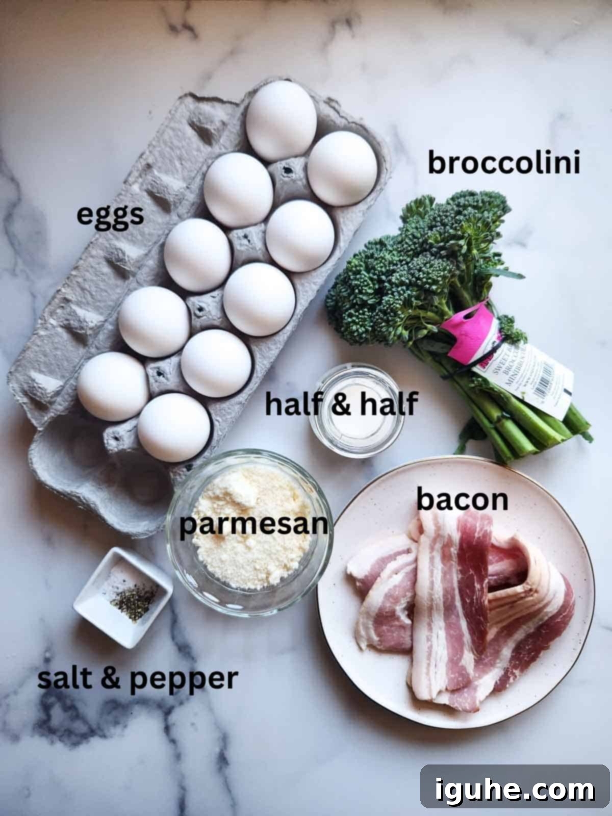 Ultimate Broccolini Bacon Parmesan Frittata 3 Overhead view of broccolini frittata ingredients on white marble.