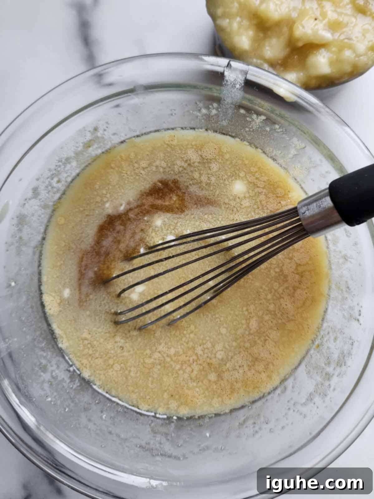 Irresistible Banana Pecan Muffins 6 Wet ingredients in a bowl for banana muffins.