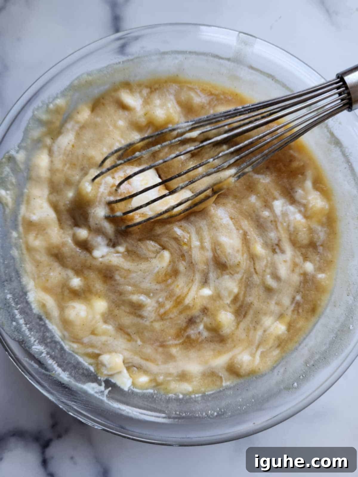 Irresistible Banana Pecan Muffins 8 Banana muffin batter in a clear bowl.