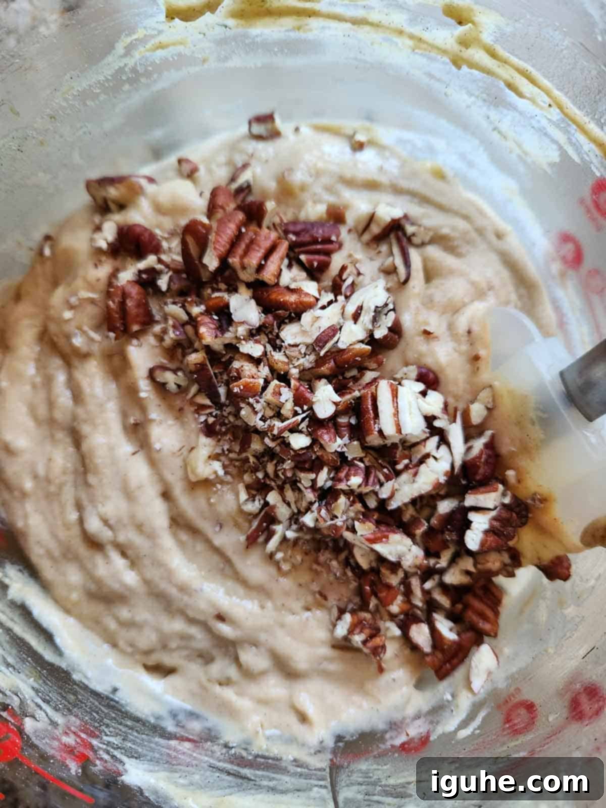 Irresistible Banana Pecan Muffins 9 Banana muffin batter with pecans in a clear bowl.