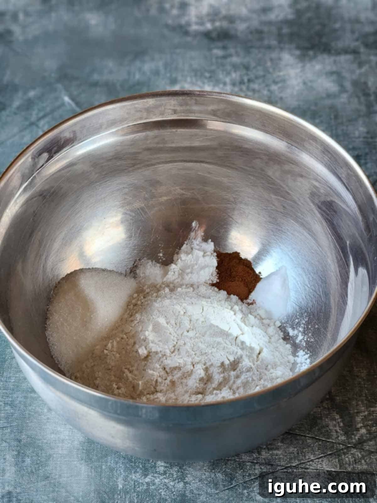 Cinnamon Swirl Sweet Cream Pancakes 4 Dry ingredients for sweet cream pancakes, including flour, sugar, cinnamon, baking powder, baking soda, and salt, mixed in a bowl.
