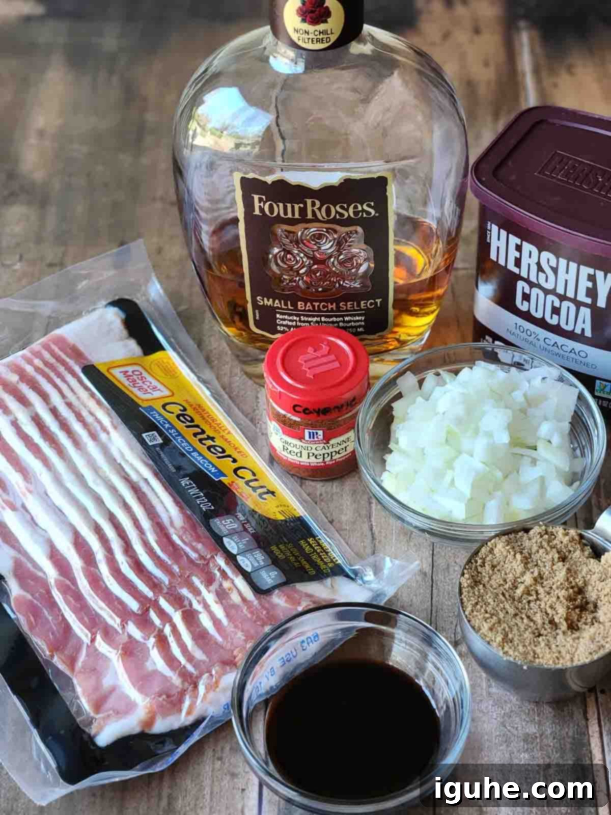 Bourbon-Kissed Bacon Bliss 3 Ingredients for bourbon bacon jam on a wood surface.