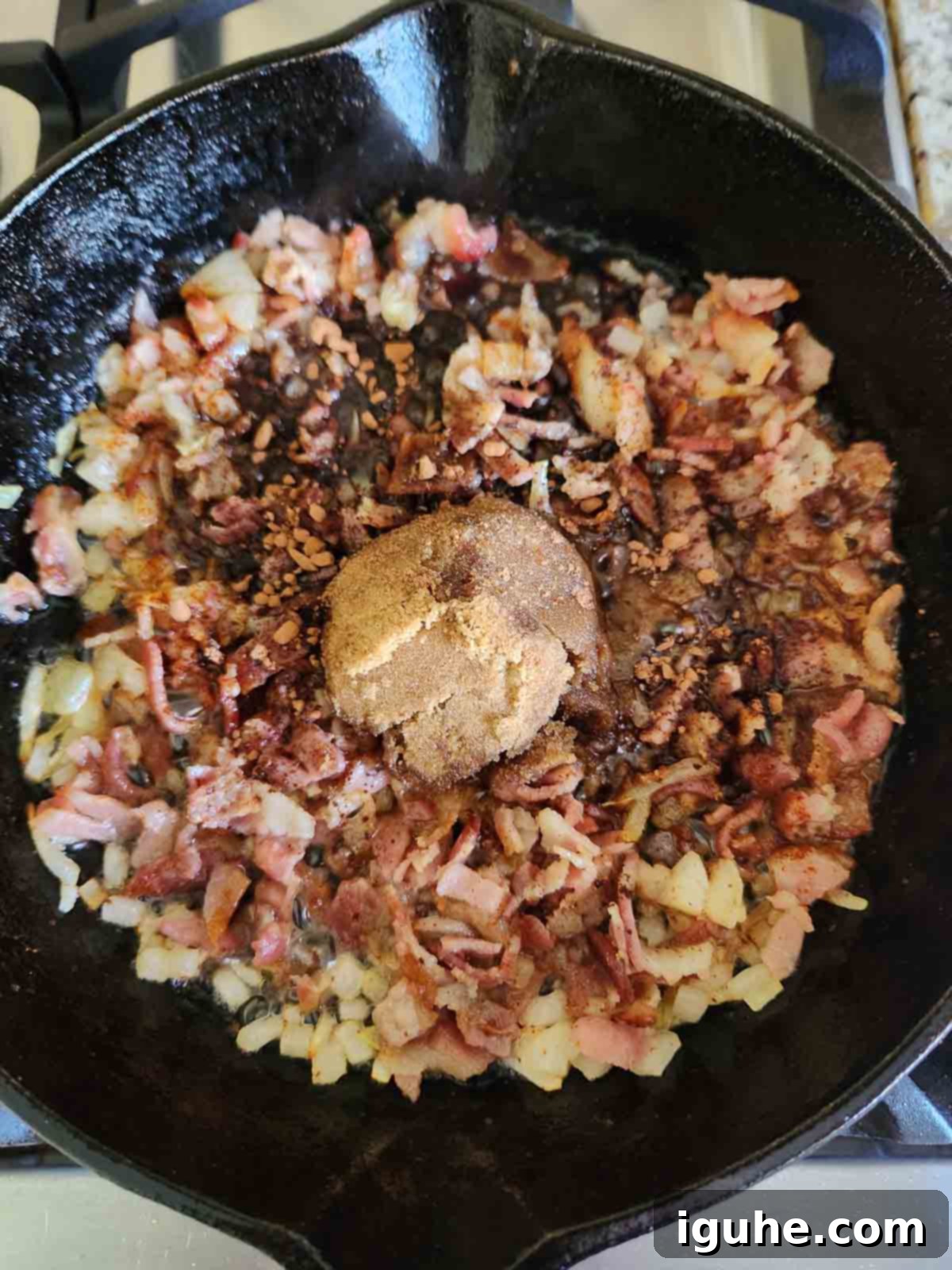 Bourbon-Kissed Bacon Bliss 6 Ingredients for bourbon bacon chutney in a cast iron skillet.