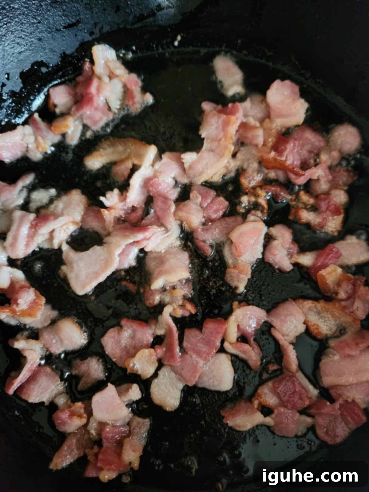Sunrise Sweet Potato Bacon Medley 6 Bacon frying in a skillet.