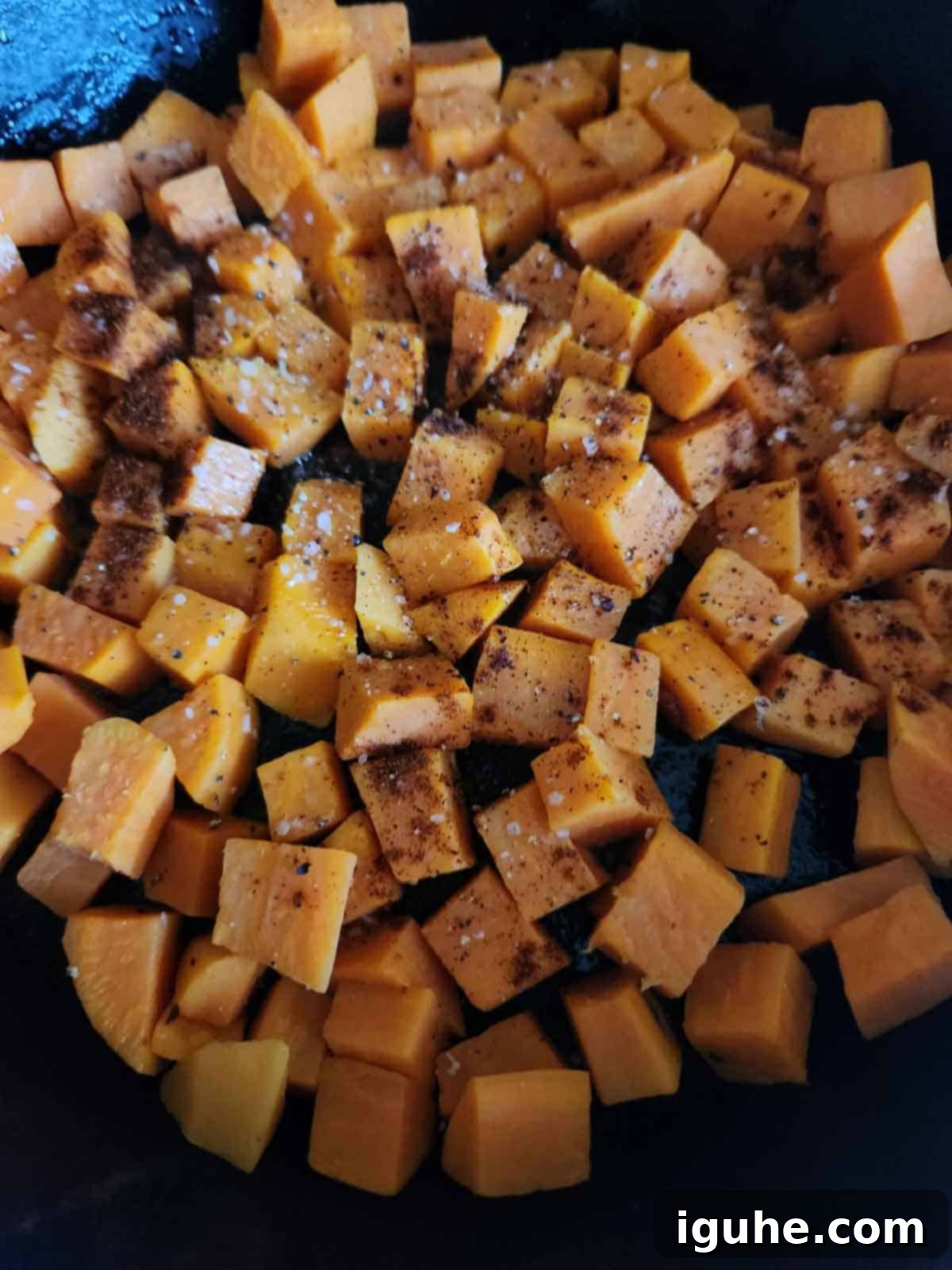 Sunrise Sweet Potato Bacon Medley 7 Cooking sweet potatoes and spices in a skillet.