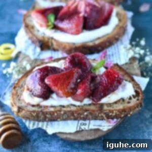 Roasted Strawberry Labneh Toast 7 Close-up of strawberry labneh toast on a cutting board.