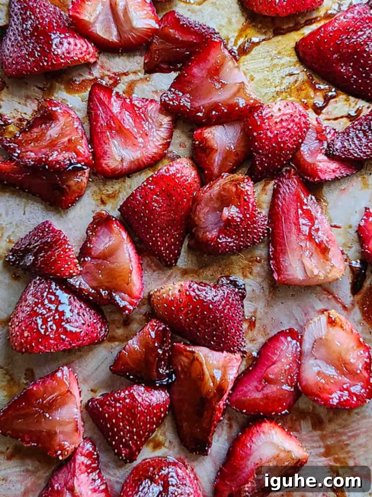 Roasted Strawberry Labneh Toast 5 Roasted strawberries on a metal baking sheet, showing caramelization.