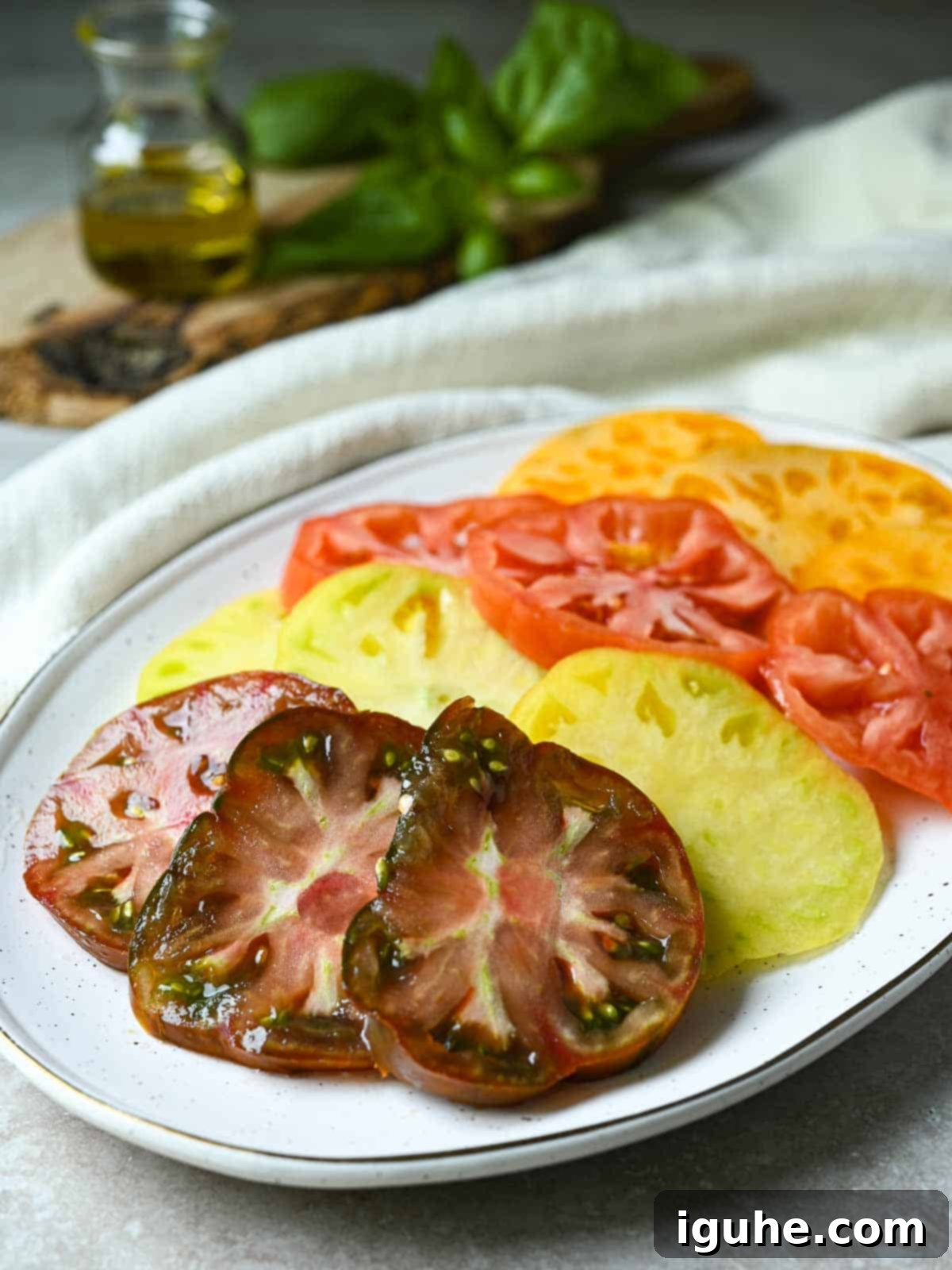 Vibrant Heirloom Caprese Salad 4 Sliced heirloom tomatoes on a platter.