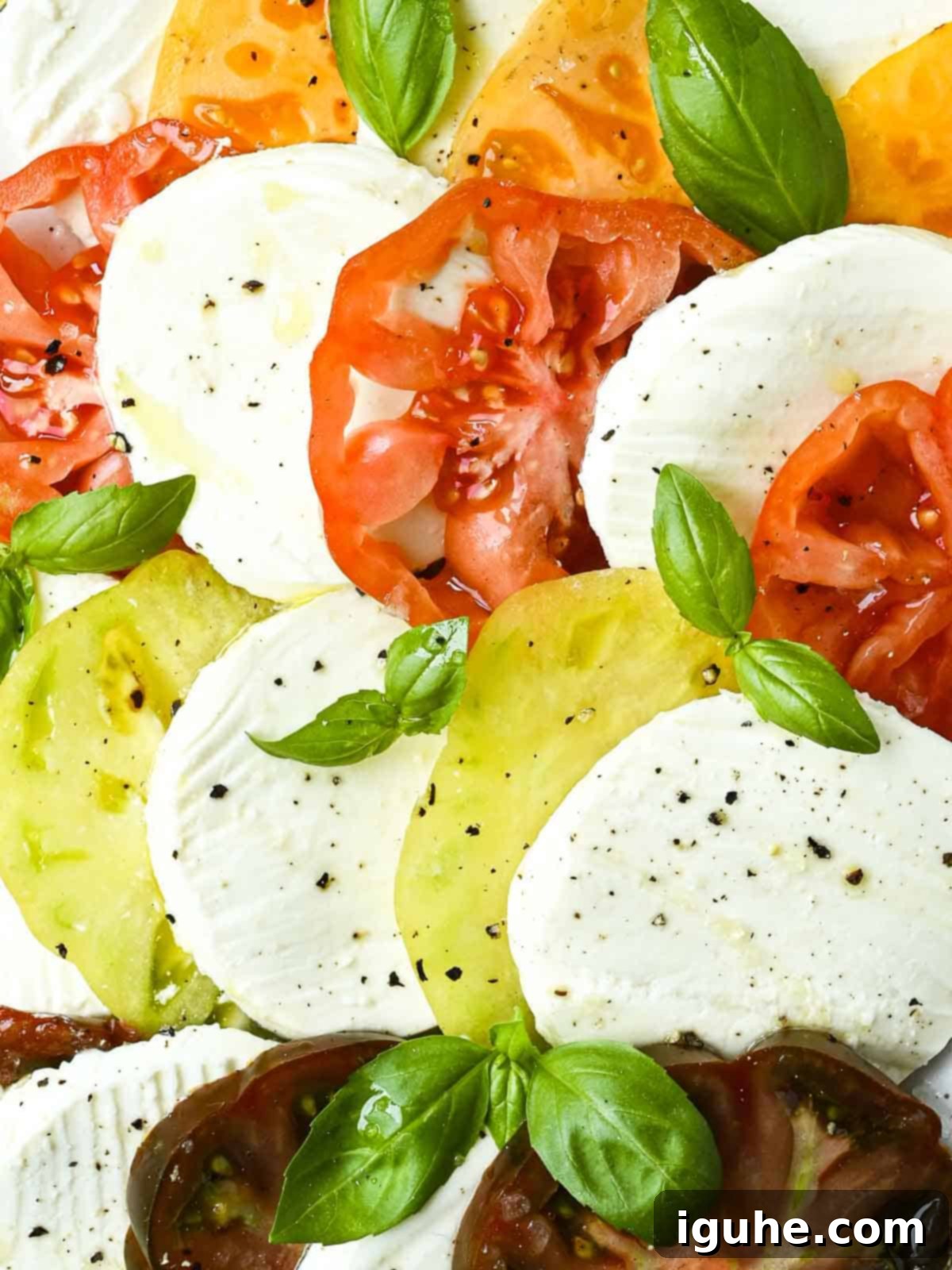 Vibrant Heirloom Caprese Salad 8 Close-up of sliced tomatoes, mozzarella, and basil.