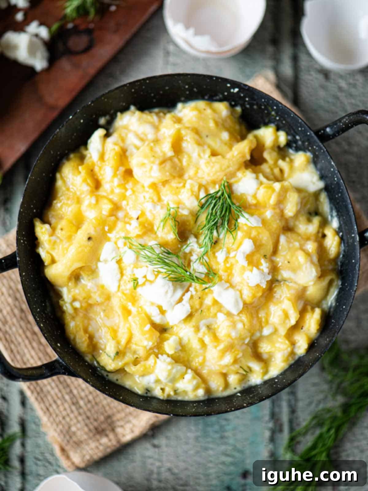 Mediterranean Feta Dill Scramble 8 Overhead of scrambled eggs in a black skillet with dill on top.