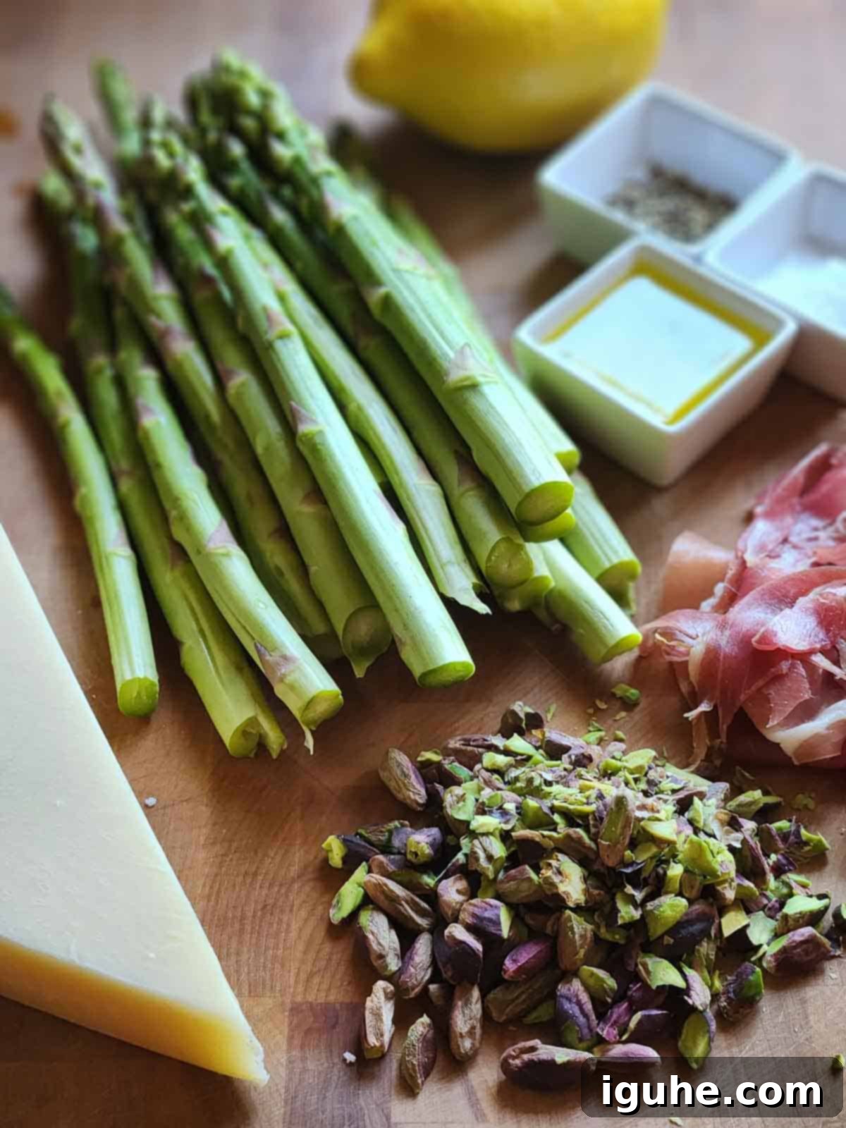 Delicate Asparagus & Prosciutto Salad 3 Ingredients for shaved asparagus salad on a cutting board.