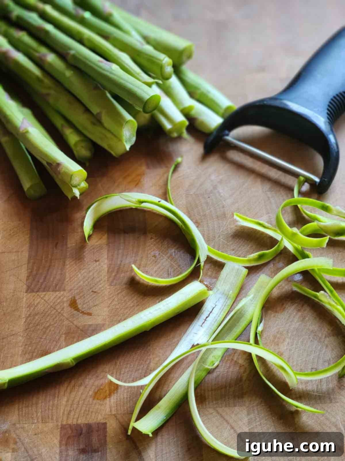 Delicate Asparagus & Prosciutto Salad 4 Showing how to shave asparagus using a peeler.