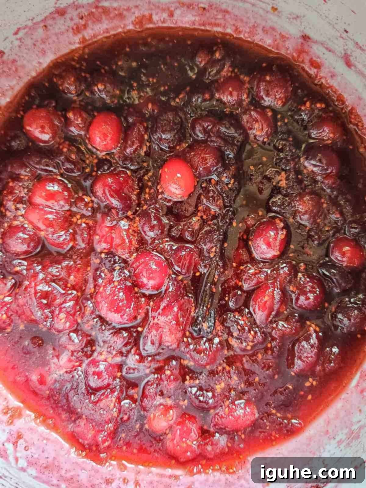 Luscious Vanilla Cranberry Compote 7 Overhead view of finished cranberry compote in a pot, ready to be removed from heat.