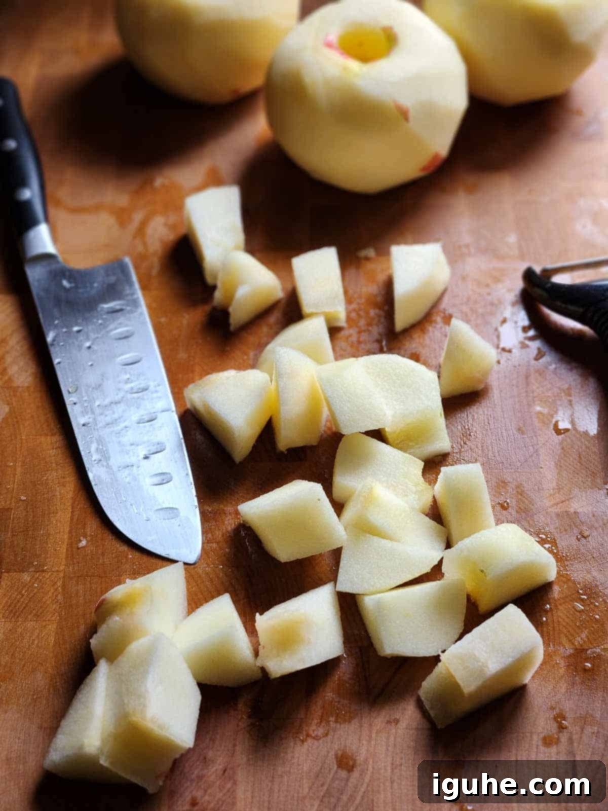 Spiced Honeycrisp Applesauce 5 Chopped apples in cubes on a cutting board.