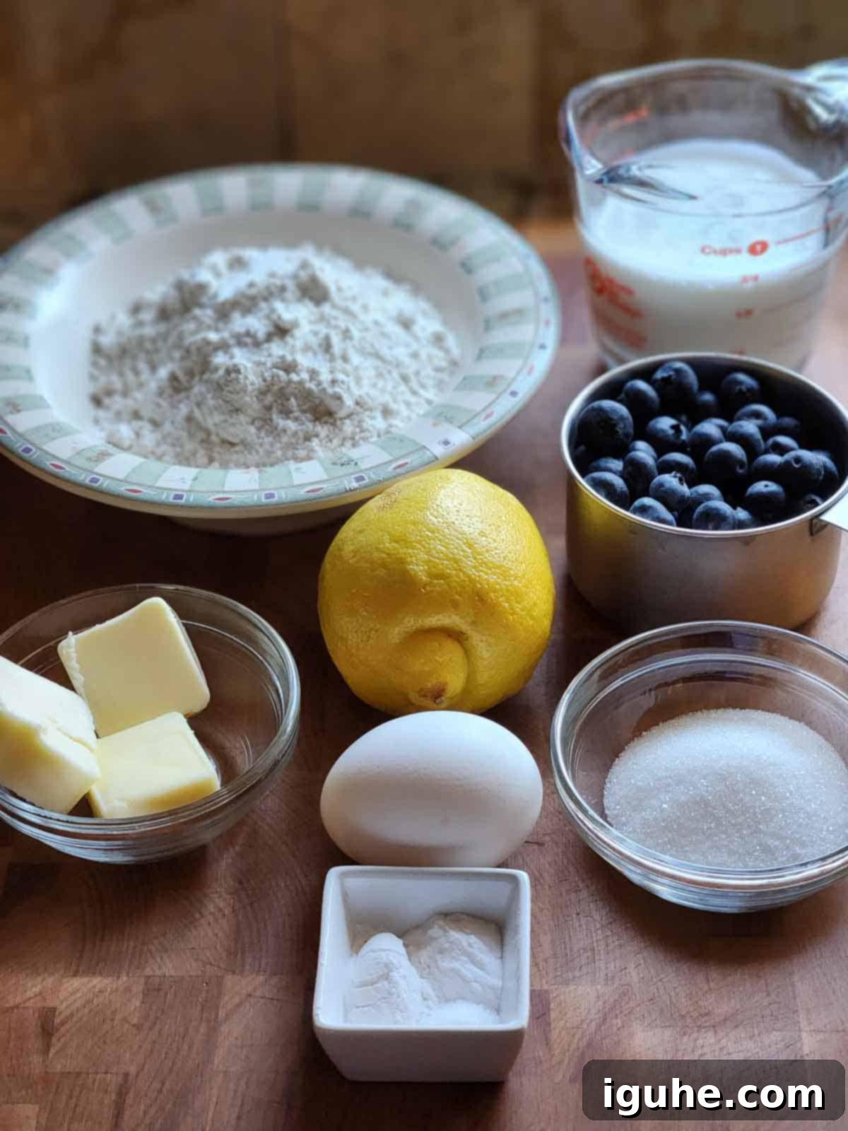Blueberry Burst Skillet Pancake 3 Ingredients for a blueberry skillet pancake on a cutting board.