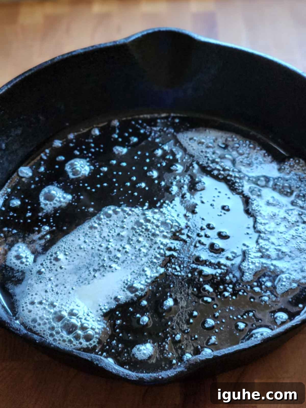 Blueberry Burst Skillet Pancake 8 Melted butter in a black skillet.