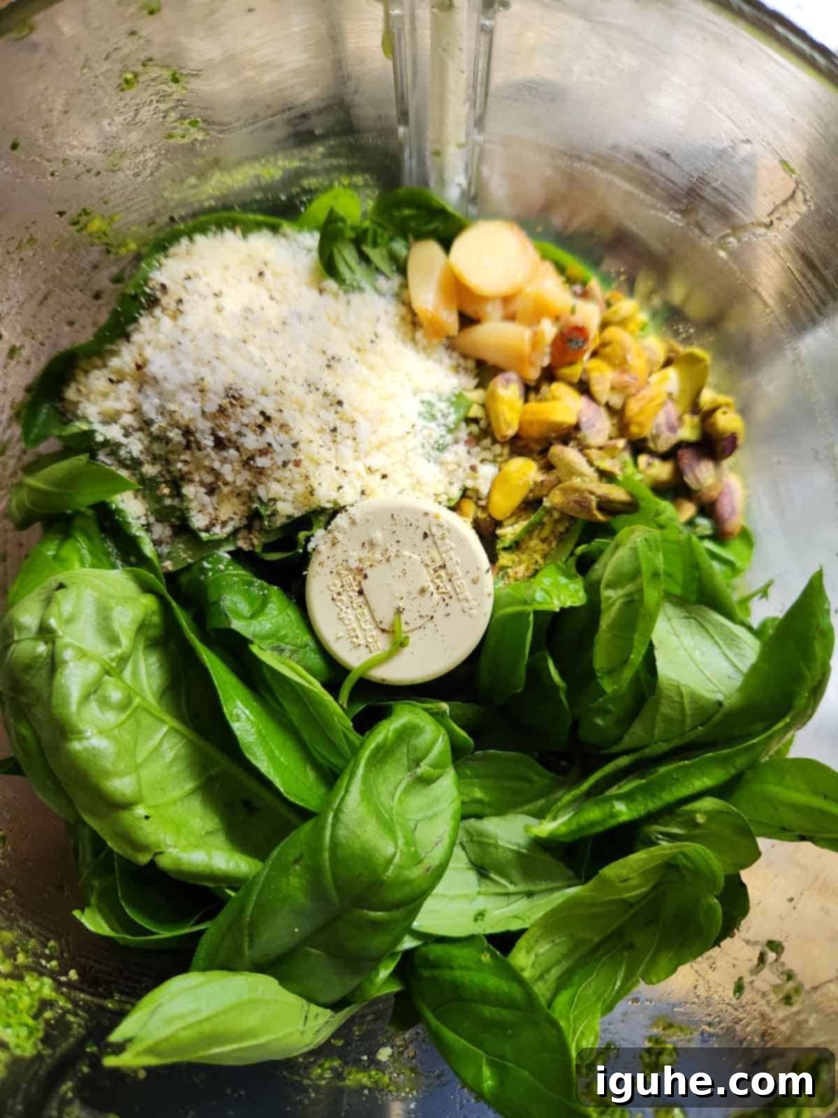 Golden Roasted Garlic Pesto 6 Ingredients for roasted garlic pesto in a food processor.