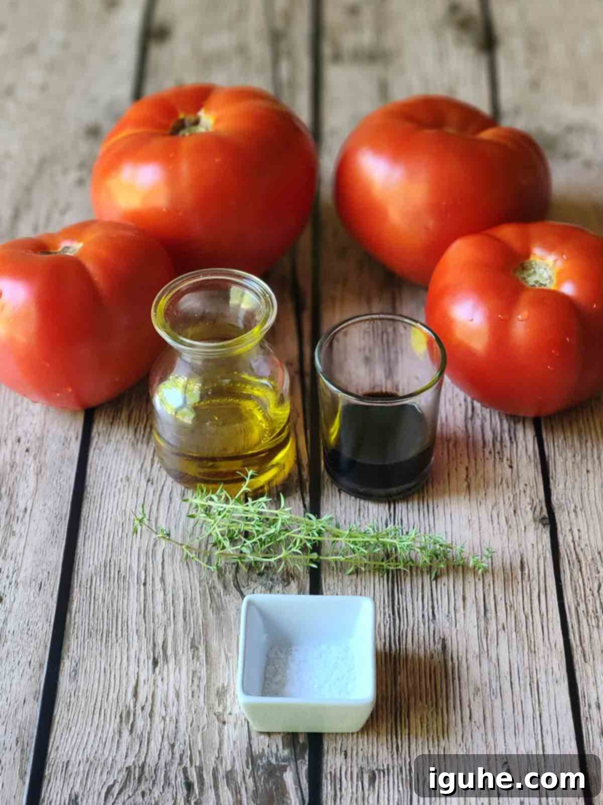 Sweet & Savory Slow Roasted Beefsteak Tomatoes 3 Ingredients for roasted tomatoes on a wooden surface.