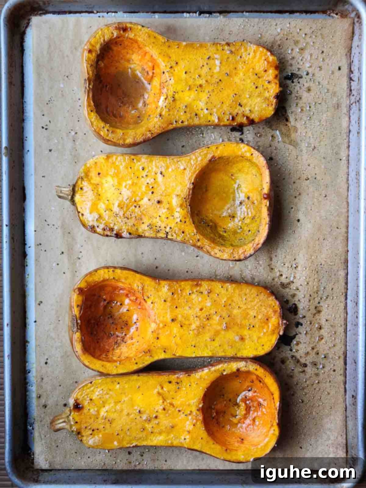Golden Harvest Squash Soup 4 Roasted squash on a baking sheet, showing tender, slightly browned flesh after cooking.