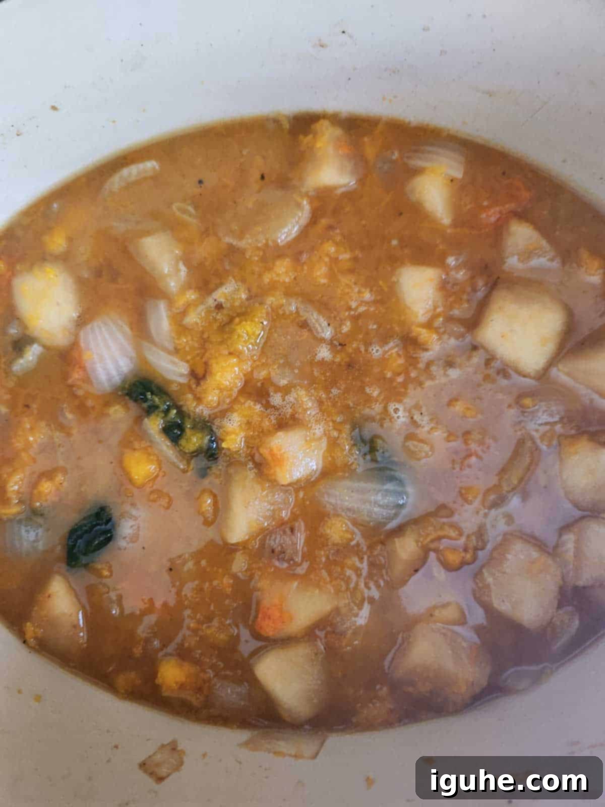 Golden Harvest Squash Soup 8 Vegetables and stock simmering gently in a pot with a lid.