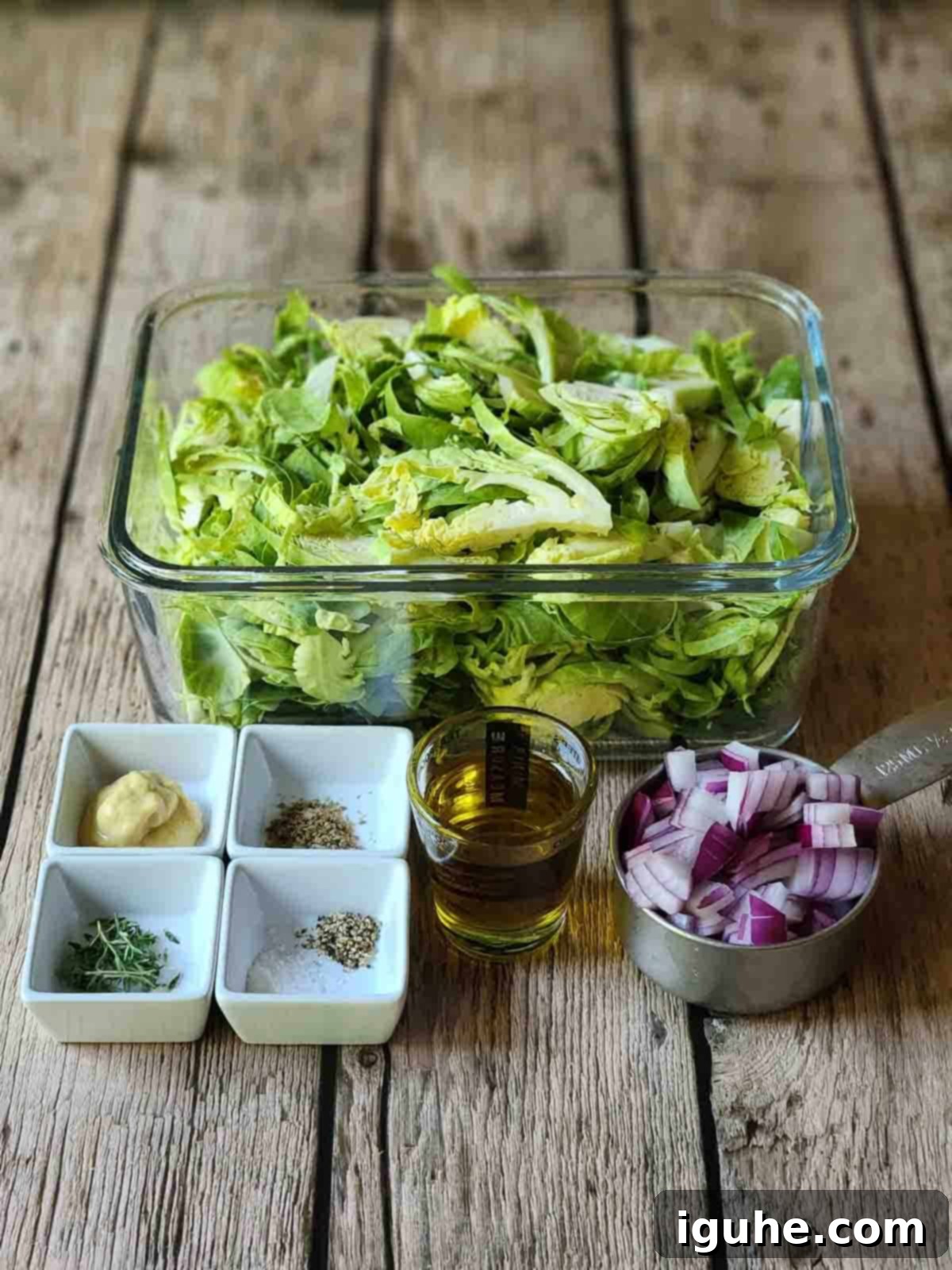 Crispy Sprout Skillet 3 Ingredients for Brussel sprout hash on a wood surface.