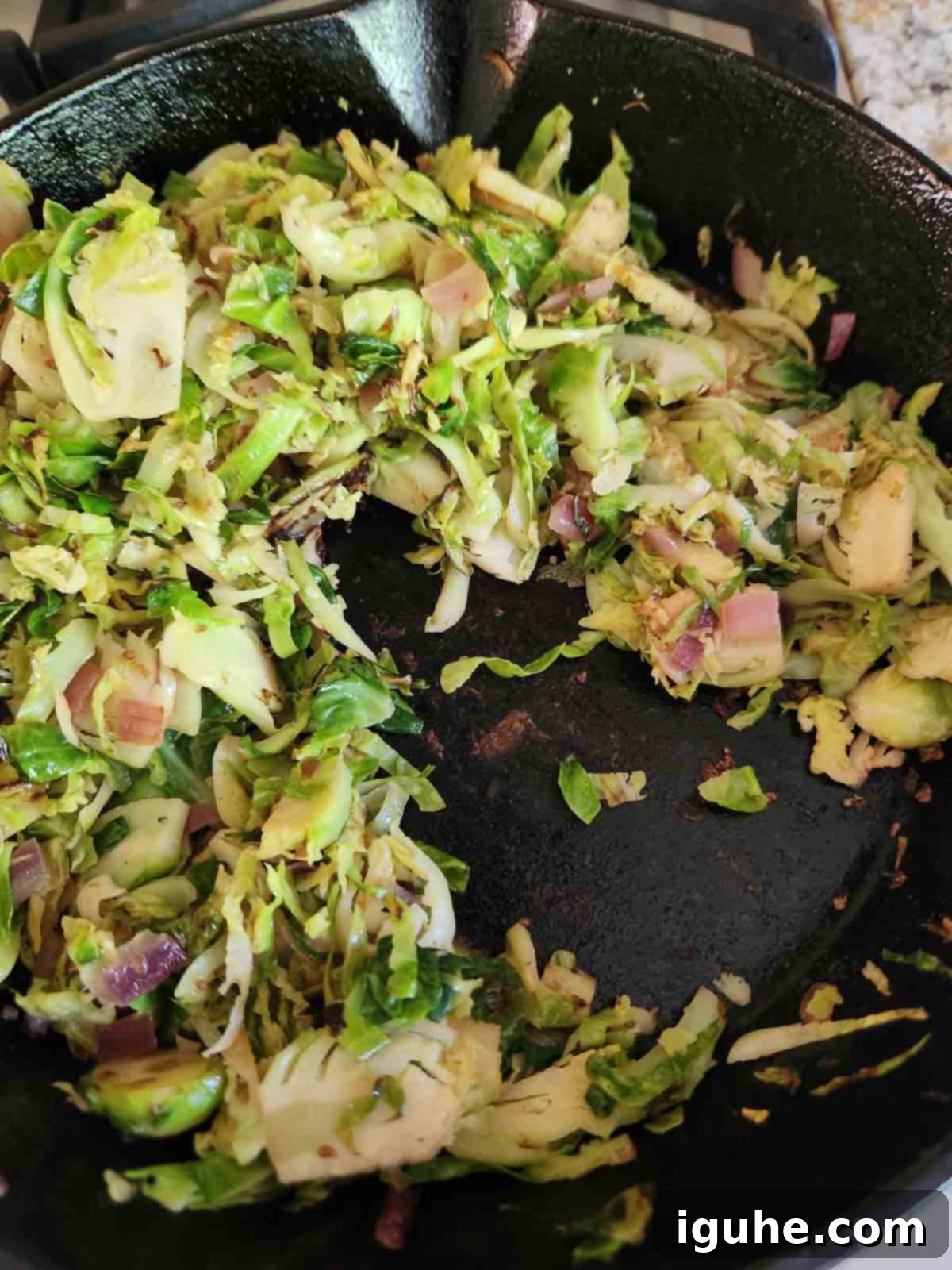 Crispy Sprout Skillet 7 Cooked Brussel sprouts in a black skillet.