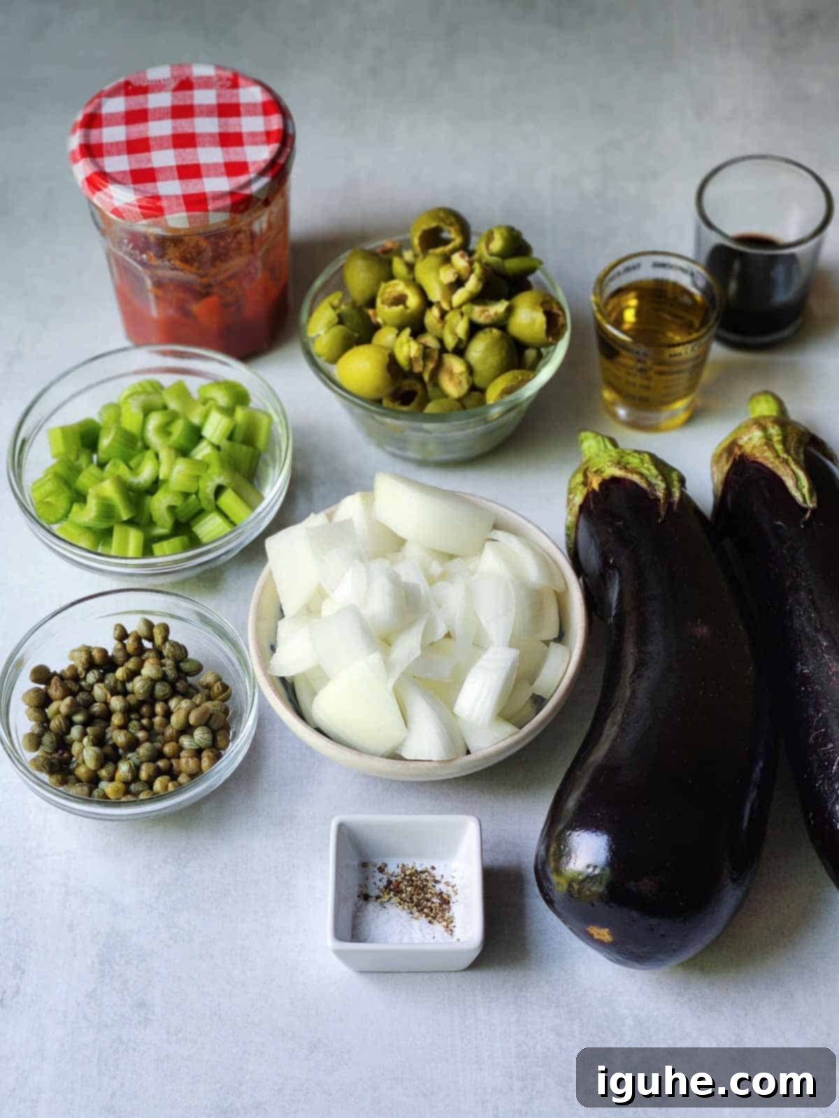Vibrant Sicilian Eggplant Caponata 3 Ingredients for Sicilian caponata on a grey surface.