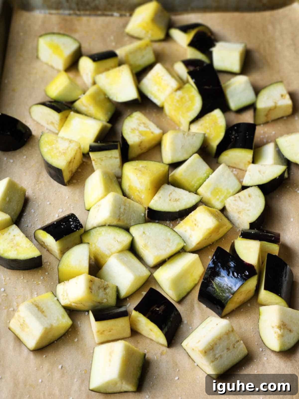 Vibrant Sicilian Eggplant Caponata 4 Chopped eggplant on parchment paper.