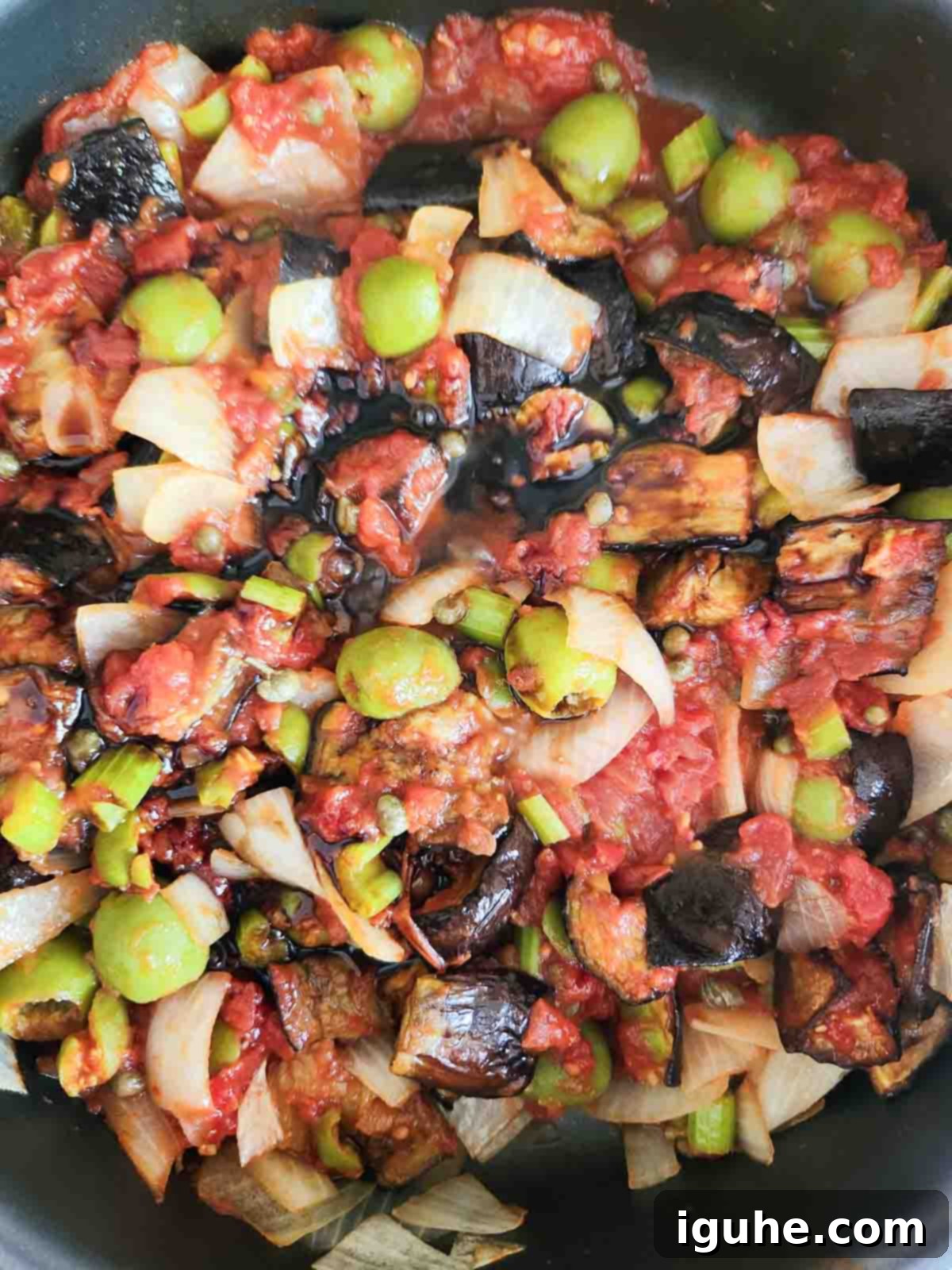 Vibrant Sicilian Eggplant Caponata 7 Caponata ingredients mixed in a pan.