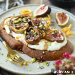 Sweet and Savory Balsamic Fig Toast 10 Close-up of a slice of gourmet fig toast on a beige plate, highlighting the roasted figs and whipped ricotta.