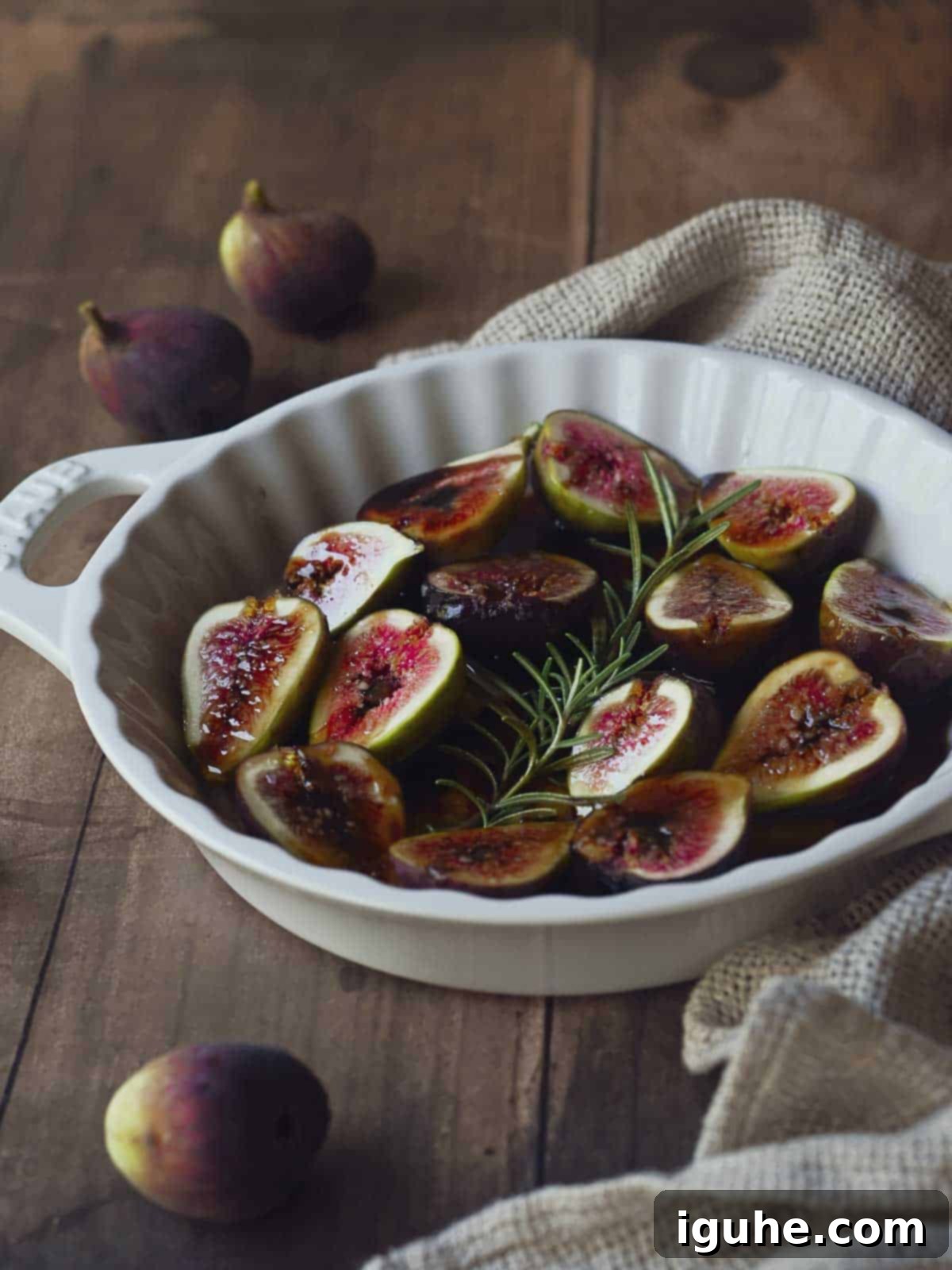 Sweet and Savory Balsamic Fig Toast 4 Fresh figs halved, arranged in a baking dish with balsamic vinegar, honey, orange liqueur, and rosemary sprigs.