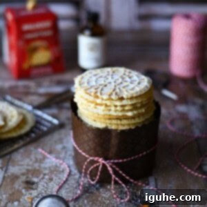 Panettone Pizzelle Treats 8 Pizzelle cookies stacked in a panetone wrapper with a bow.