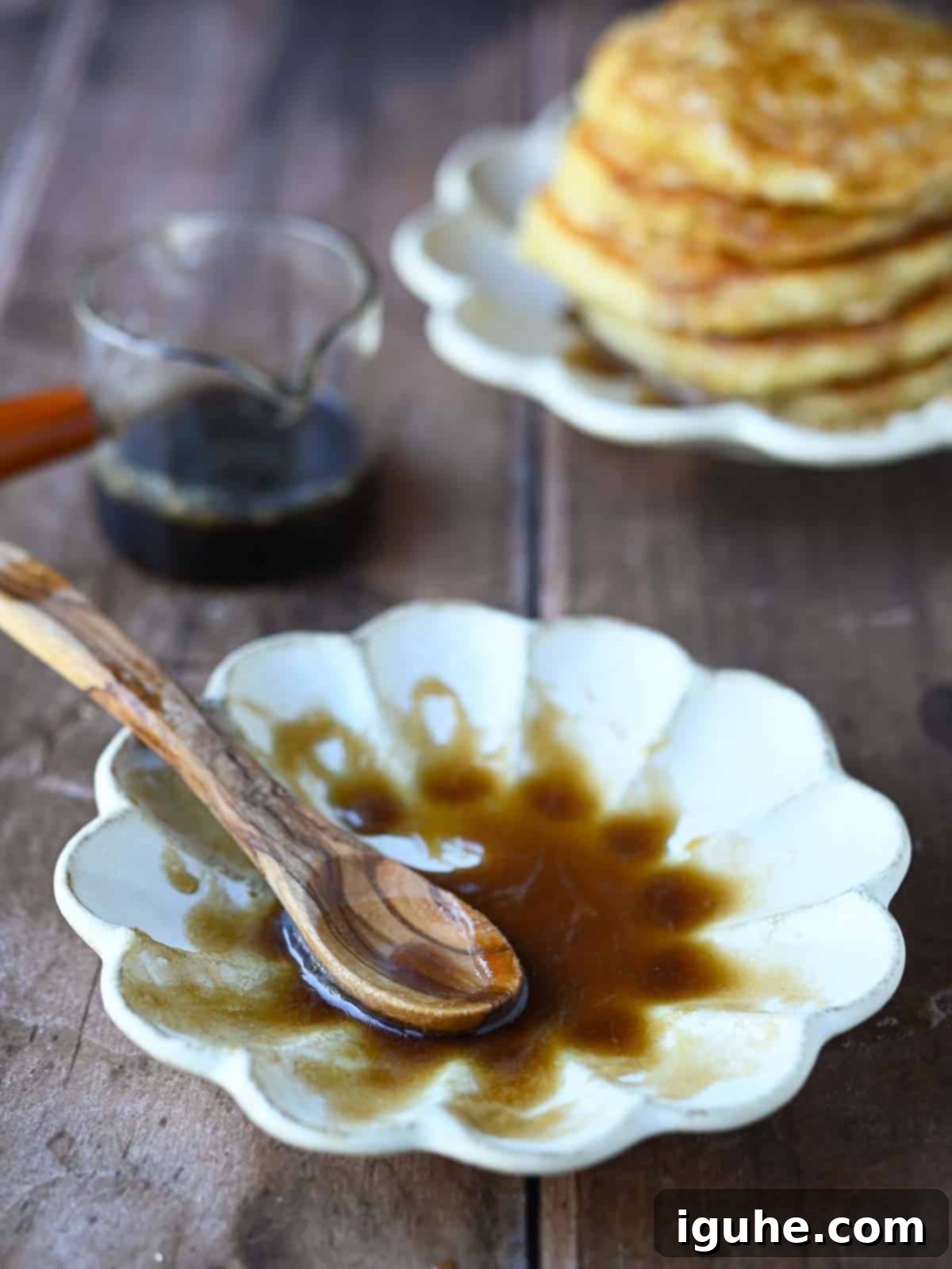 Decadent Brown Sugar Stacks 10 Rich, golden brown sugar syrup in a beige flower-shaped bowl, ready to be poured over pancakes.