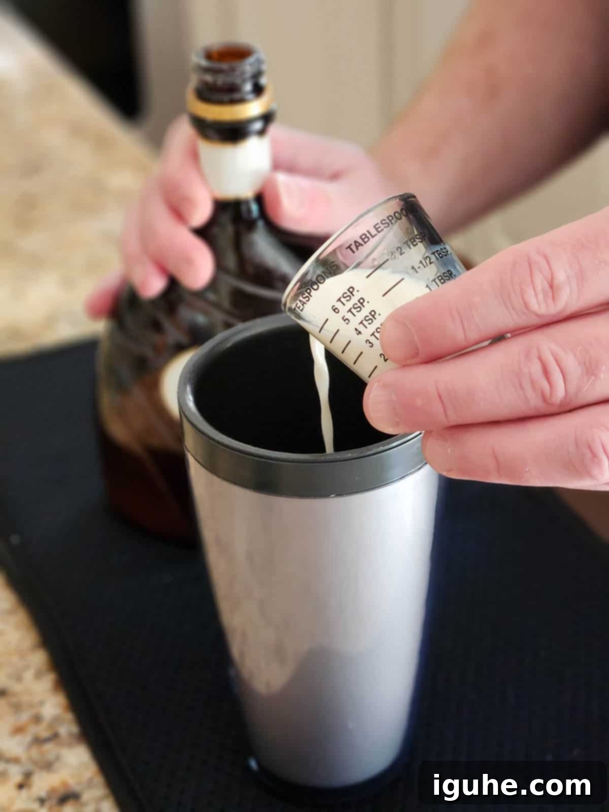 Velvet White Chocolate Pistachio Martini 4 Liqueur being poured into a cocktail shaker.