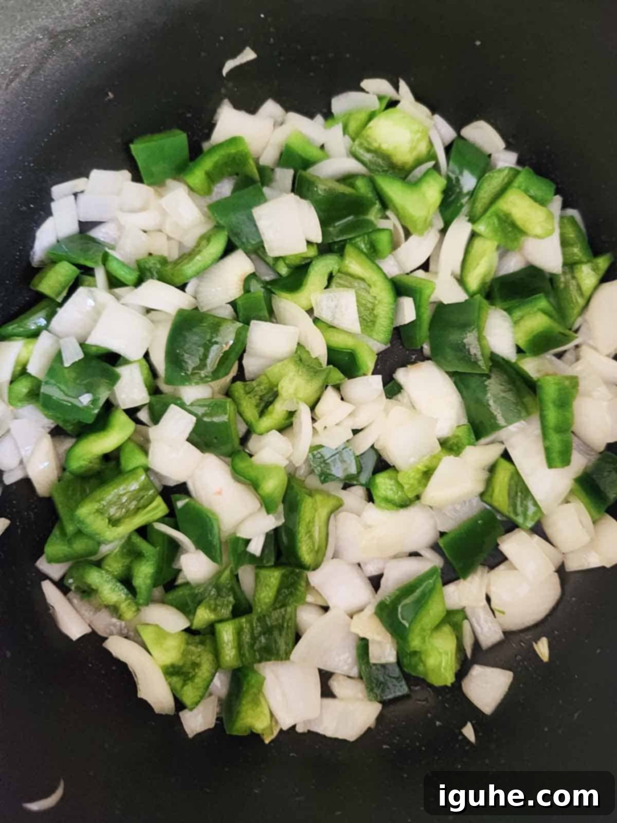 Fire Roasted Turkey Chili 4 Chopped onions and bell peppers sautéing in a large pot with olive oil.