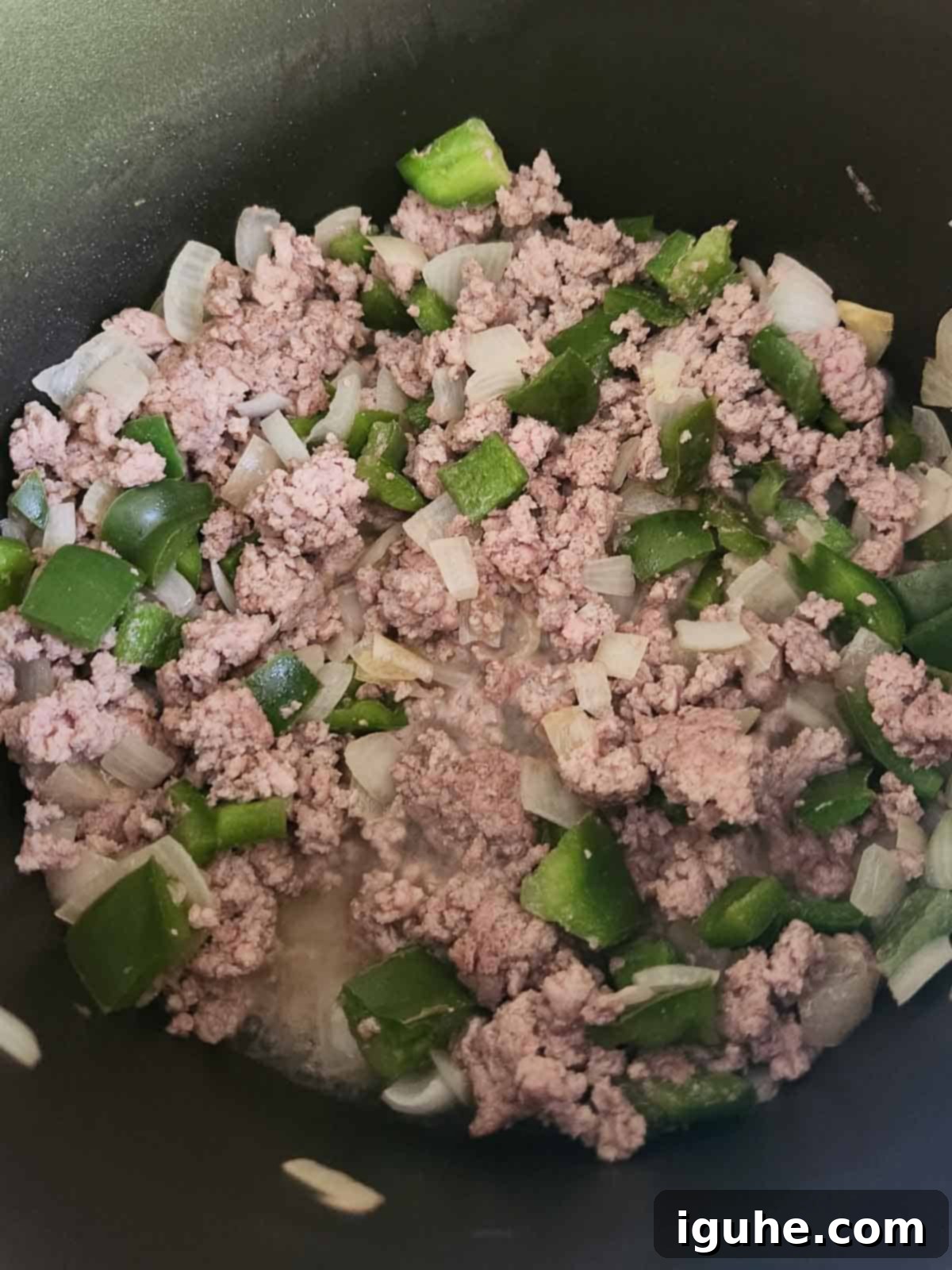 Fire Roasted Turkey Chili 5 Ground turkey browning with vegetables in a pot.