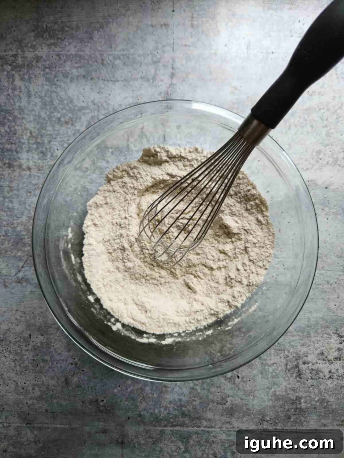 Apple-Kissed Zucchini Muffins 4 Dry ingredients for muffins in a clear bowl.
